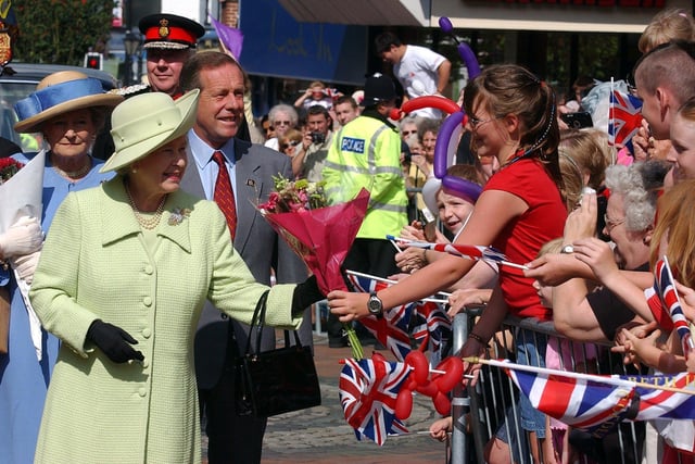 The Queen meets gets flowers from Emily Nelson, nine, during a visit to her newest city - Preston - on her Jubilee tour