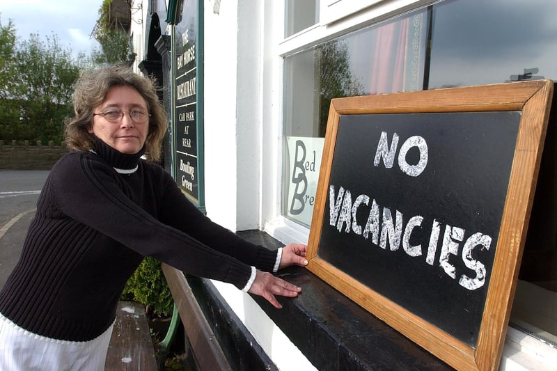 Landlady of the Bay Horse Hotel, Chorley, Barbara Trim puts up the no vacancies sign for rooms during the Commonwealth Games, 2002