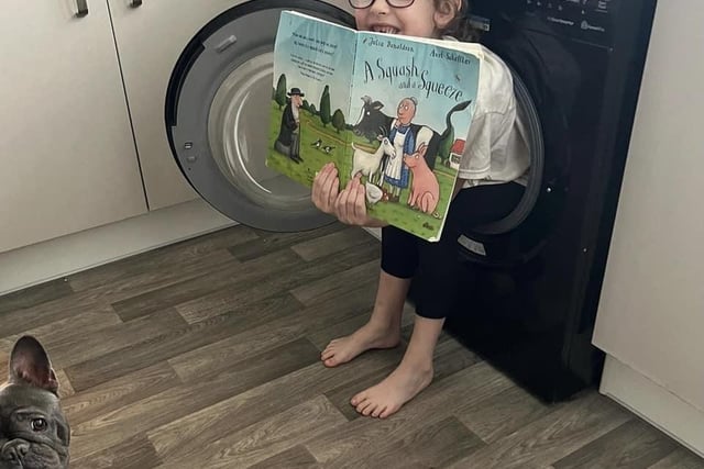"No dressing up for world book day today at Emilie’s school. However.. we had to read a story in a strange place! It was “A squash and a squeeze” to get into the washer": Lisa Savoini