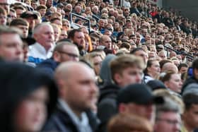 Preston North End fans watch their team in action