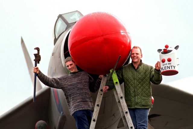 Lightning Strike workers Mark Evans and Andy Garlick, from the British Aerospace factory at Samlesbury, near Preston, put the finishing touches to the Comic Relief Red Nose they made and fitted to Lightning Jet aircraft at the site