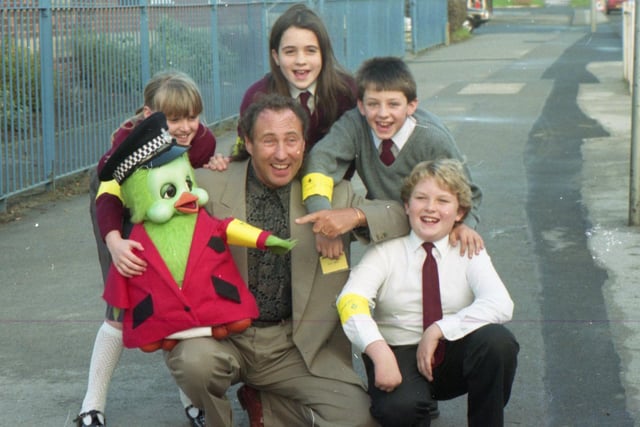 Orville the duck shrugged off his shyness to launch a special police safety campaign in Lancashire. British Aerospace also joined forces with entertainer Keith Harris, Orville and his pal Cuddles to promote an armband scheme which aims to get youngsters noticed in the dark. Pictured are schoolchildren from the Fylde area with Keith Harris and Orville, all sporting the armbands