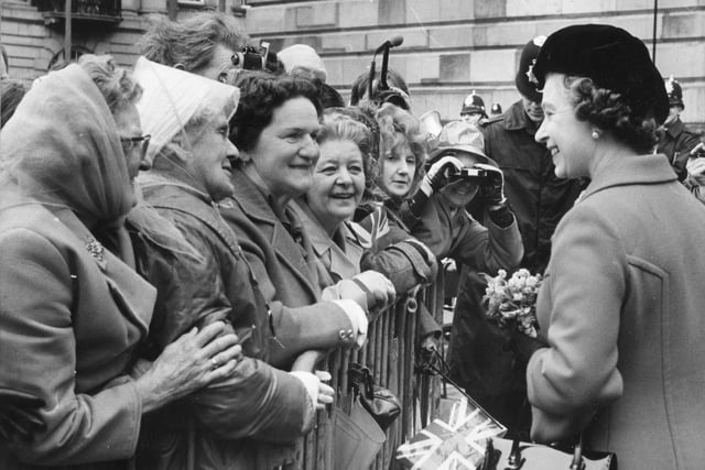 Smiling faces all round as the Queen stops for a few words with these ladies on Preston's Flag Market in 1979