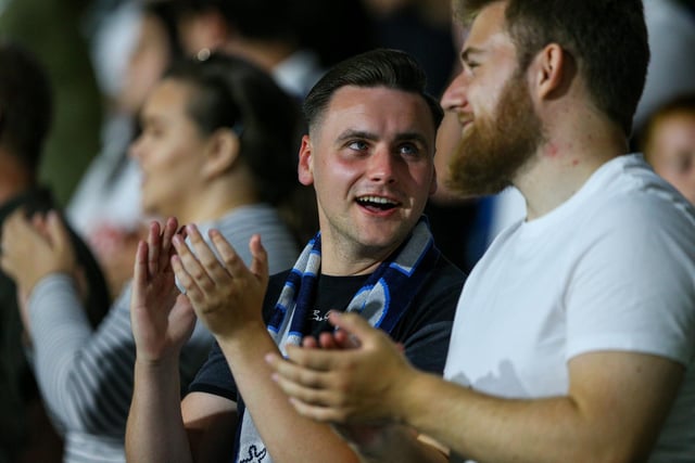 Two Preston fans chat as they watch on.