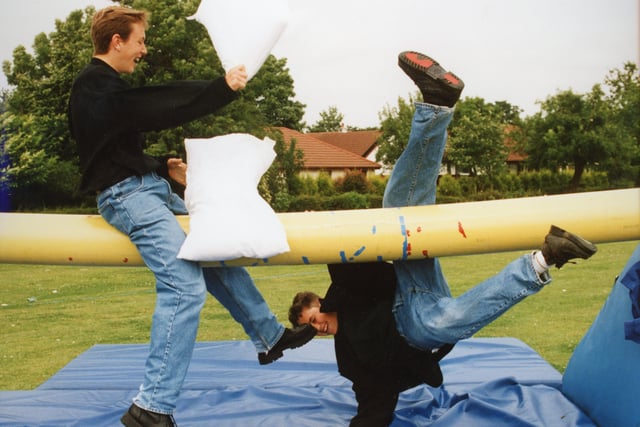 Mark Ingleson (left) emerges victorious in the pillow fight as James Edmonds takes a tumble at the Broughton High School gala