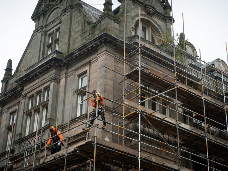 Workmen erecting scaffolding on the former Post Office building in Preston City Centre