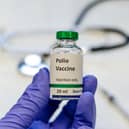 Poliomyelitis virus vaccine with stethoscope and syringe at the background