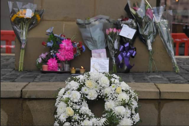 Floral tributes left at the obelisk on Preston's Flag Market.