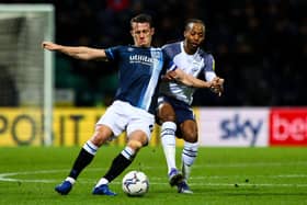 Huddersfield Town's Jonathan Hogg vies for possession with Preston North End's Daniel Johnson.