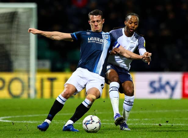 Huddersfield Town's Jonathan Hogg vies for possession with Preston North End's Daniel Johnson.