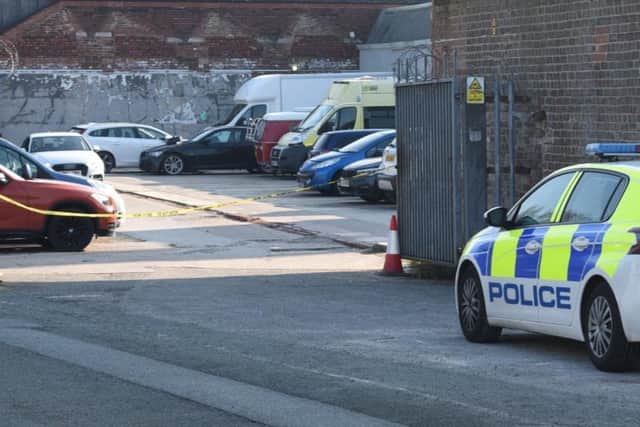 The taped off car park appears to serve several industrial units