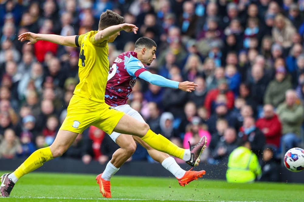 Burnley’s Anass Zaroury shoots under pressure from Preston North End’s Jordan Storey