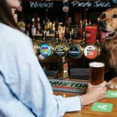 Golden Retriever Huxley enjoys a drink in the pub with friends. The Bellflower at Garstang has been named Britain's most dog friendly pub.Picture credit: © Rover.com