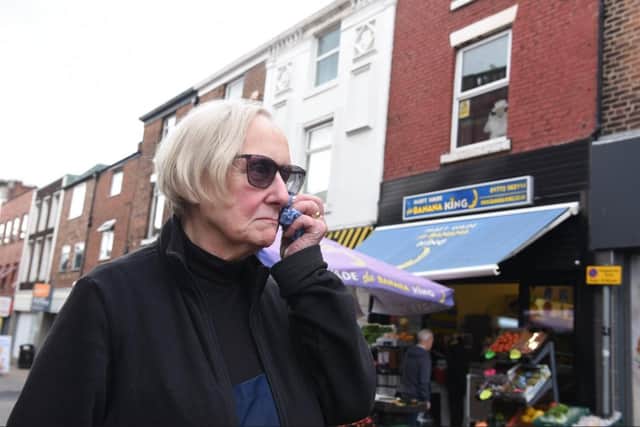 A tearful Ellen Young outside the Banana King shop in Orchard Street.
