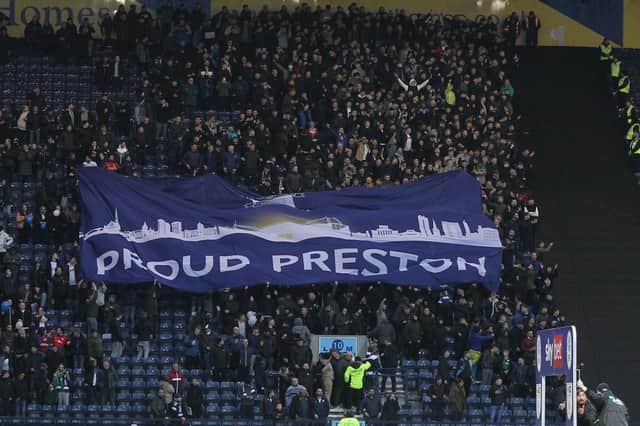 PNE fans parade the Preston Skyline surfer flag in the Bill Shankly Kop before the game
