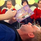 Storyteller Fran O'Boyle works on his book review with (from left) Claudia Fisher-Godwin, Heather Skachill, Marguerite Ralphs and Samantha Bentley from Penwortham Girls High School, near Preston, during book week in 1999