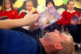 Storyteller Fran O'Boyle works on his book review with (from left) Claudia Fisher-Godwin, Heather Skachill, Marguerite Ralphs and Samantha Bentley from Penwortham Girls High School, near Preston, during book week in 1999