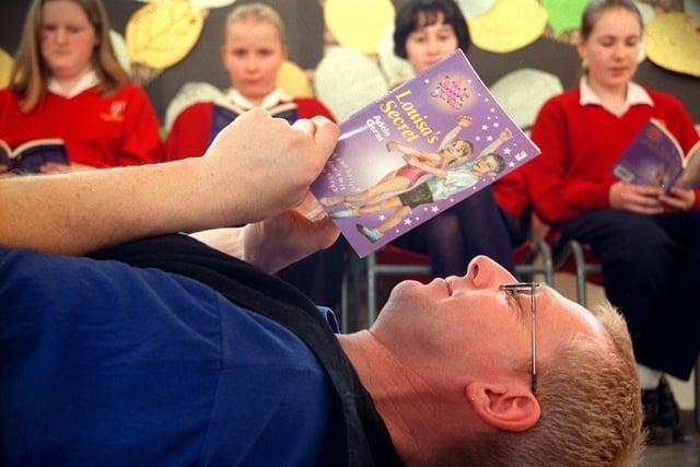 Storyteller Fran O'Boyle works on his book review with (from left) Claudia Fisher-Godwin, Heather Skachill, Marguerite Ralphs and Samantha Bentley from Penwortham Girls High School, near Preston, during book week in 1999