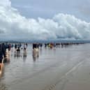 Hundreds of hardy hikers braved freak weather conditions to complete the Cross Bay Walk.
