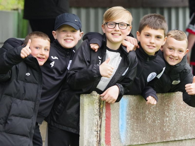 More young fans pose for a photo as they enjoy their afternoon and the football