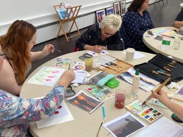 All ages enjoying a free watercolour workshop with Lidia Ranns