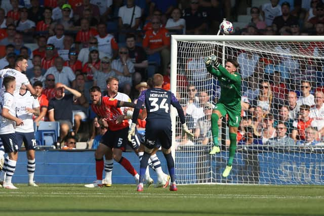 Preston North End's Freddie Woodman punches clear at Kenilworth Road