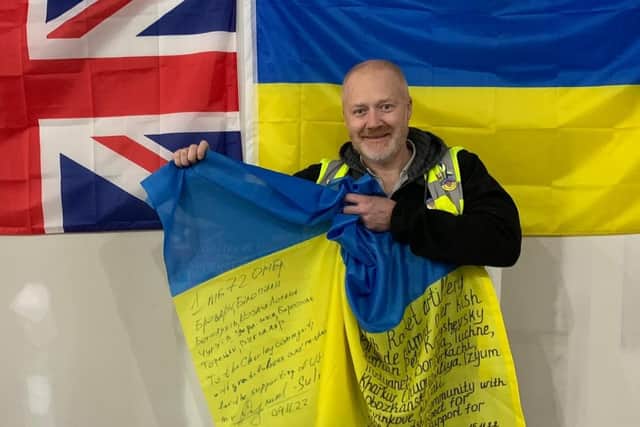 Chorley and District's group co-ordinator and volunteer Stuart Clewlow pictured with the flag he received from Ukraine as a thank you for helping with relief aid supplies