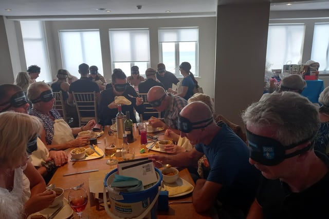 People tuck in to their roast dinners while wearing blindfolds