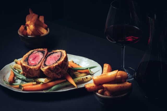 30 day aged filled of beef wellington with mushroom duxcell, wholegrain mustard, pancetta, puff pastry, beef fat chips, seasonal vegetables