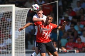 Liam Lindsay wins a header against Luton Town.