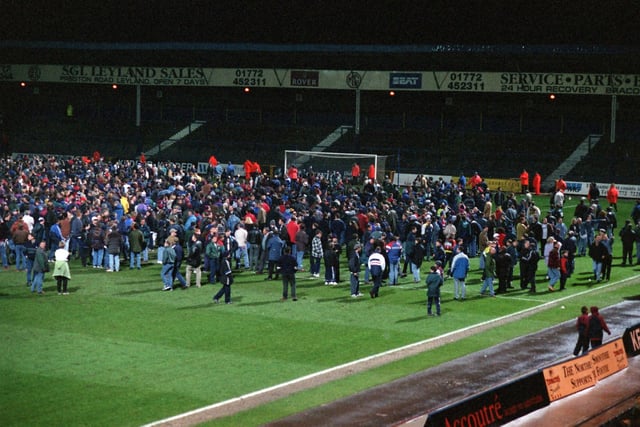 Evacuated PNE fans from the Town End stand  during the first half of the match against Wrexham was disrupted by a small fire. - fans on the pitch - preston north end fire - March 1997