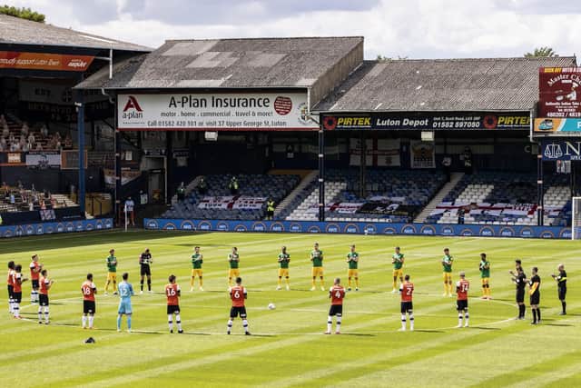 Players observe a minute's silence ahead of the match.
