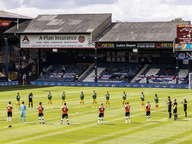 Players observe a minute's silence ahead of the match.