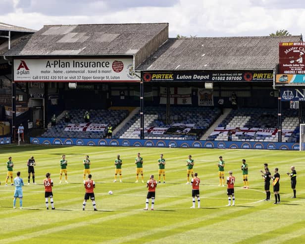 Players observe a minute's silence ahead of the match.