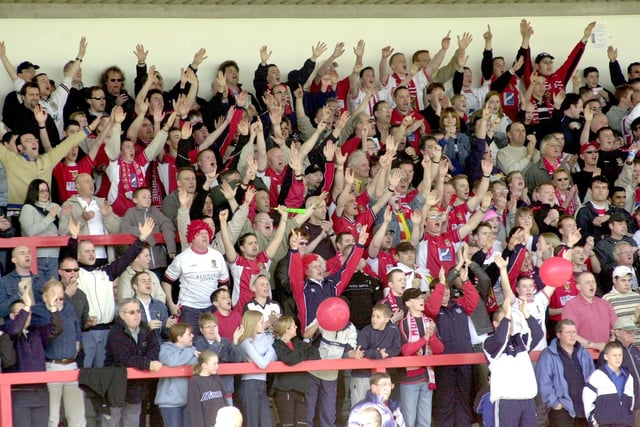 Morecambe fans welcome their team during the FA Trophy match against Stevenage Borough