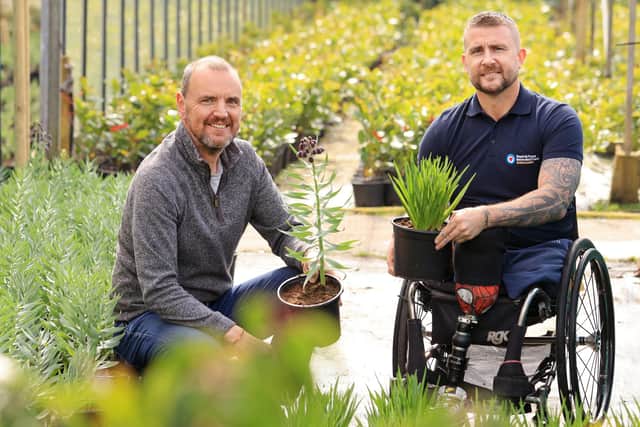 John Everiss (left) and Stuart Robinson examine plants being grown for The RAF Benevolent Fund garden    Photo: Oliver Dixon