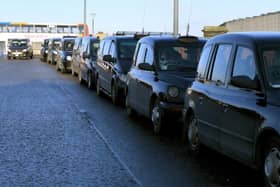 Taxis queue for customers outside Preston Railway Station.