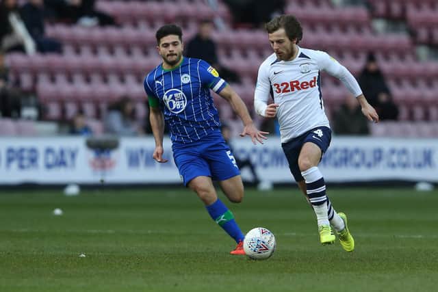 Ben Pearson is chased down by Wigan's Sam Morsy.