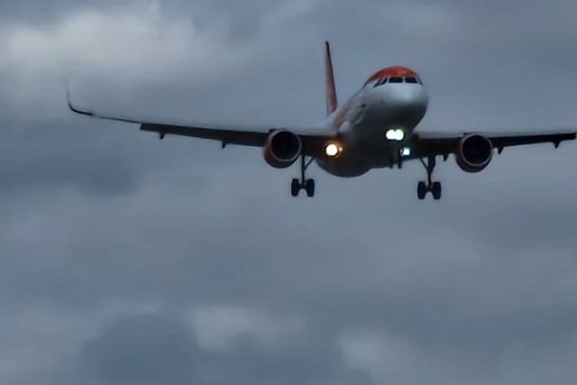 A plane heads to Manchester Airport bringing holidaymakers home
