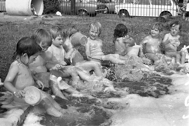 Bath time was never like this... and what a sneaky way these grown-ups have of keeping us clean! Children of the Hartington Road Day Nursery, Preston, don't know anything about centigrade and fahrenheit but they reckon that clothes are just a waste of time when the sun is beating down and there's a paddling pool outside. But never mind the heatwave...