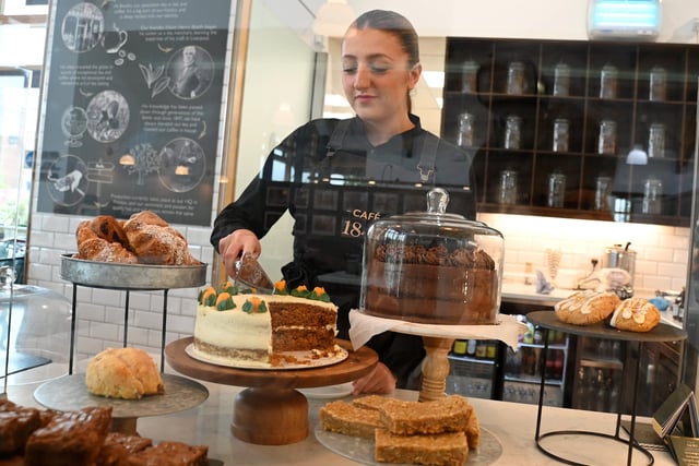 Cafe staff member Antonia Hirons slices some carrot cake