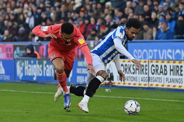 Cyrus Christie (left) in action for Swansea against Huddersfield Town's Josh Koroma