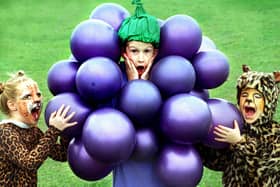 Children at Lytham Hall Park Primary School rounded off their 1997 Book Week activities with a fancy-dress breakfast. Nine-year-old Jonathan Cooper was rather regretting coming dressed as bunch of grapes, when five-year-old Thomas Williams and seven-year-old Samantha Read decided they were still hungry!