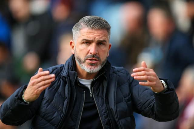 Preston North End manager Ryan Lowe tries to gee up the fans as he leaves the field at half time