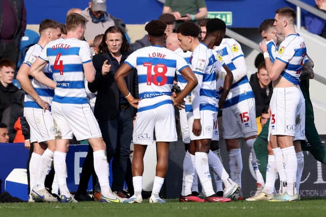 Gareth Ainsworth speaks to his Queens Park Rangers players by the side of the pitch