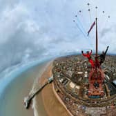 Two thrill-seekers scaled the 518ft Blackpool Tower for a selfie with a Red Arrows display. Adam Collins, Officer Commanding the Red Arrows, was at the top of the flag pole on the tower saluting them as they flew past. See SWNS story SWMRtower. 