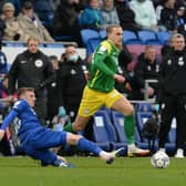 Preston North End's Brad Potts rides the sliding tackle from Cardiff City's Alfie Doughty.