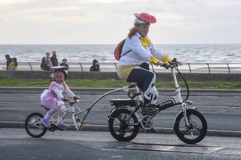 Hitching a lift with mum seems a good idea during Ride the Lights 2023. Photos by Dan Martino