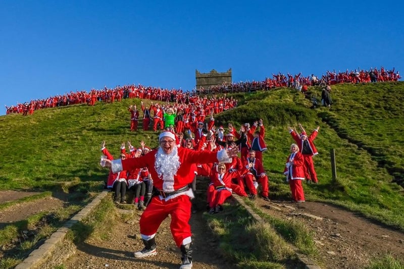 Derian ambassador Neil Hailwood celebrates with a lot of Santas