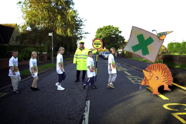 Our Lady and St Edward's School pupils, from left, Ashley Sleight, Laura Welsby, Colette Sudlow, Antony Proctor, and Alex Graveson, cross the road with the help of the Child Road Safety Campaign hedgehog in Fulwood, Preston